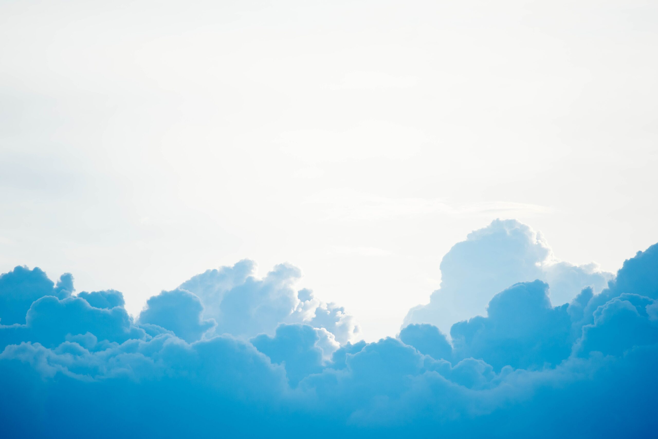 Bright blue sky with fluffy cloud formations.